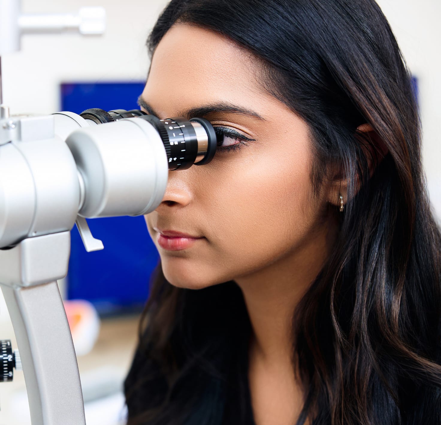 Woman looking in an eye instrument