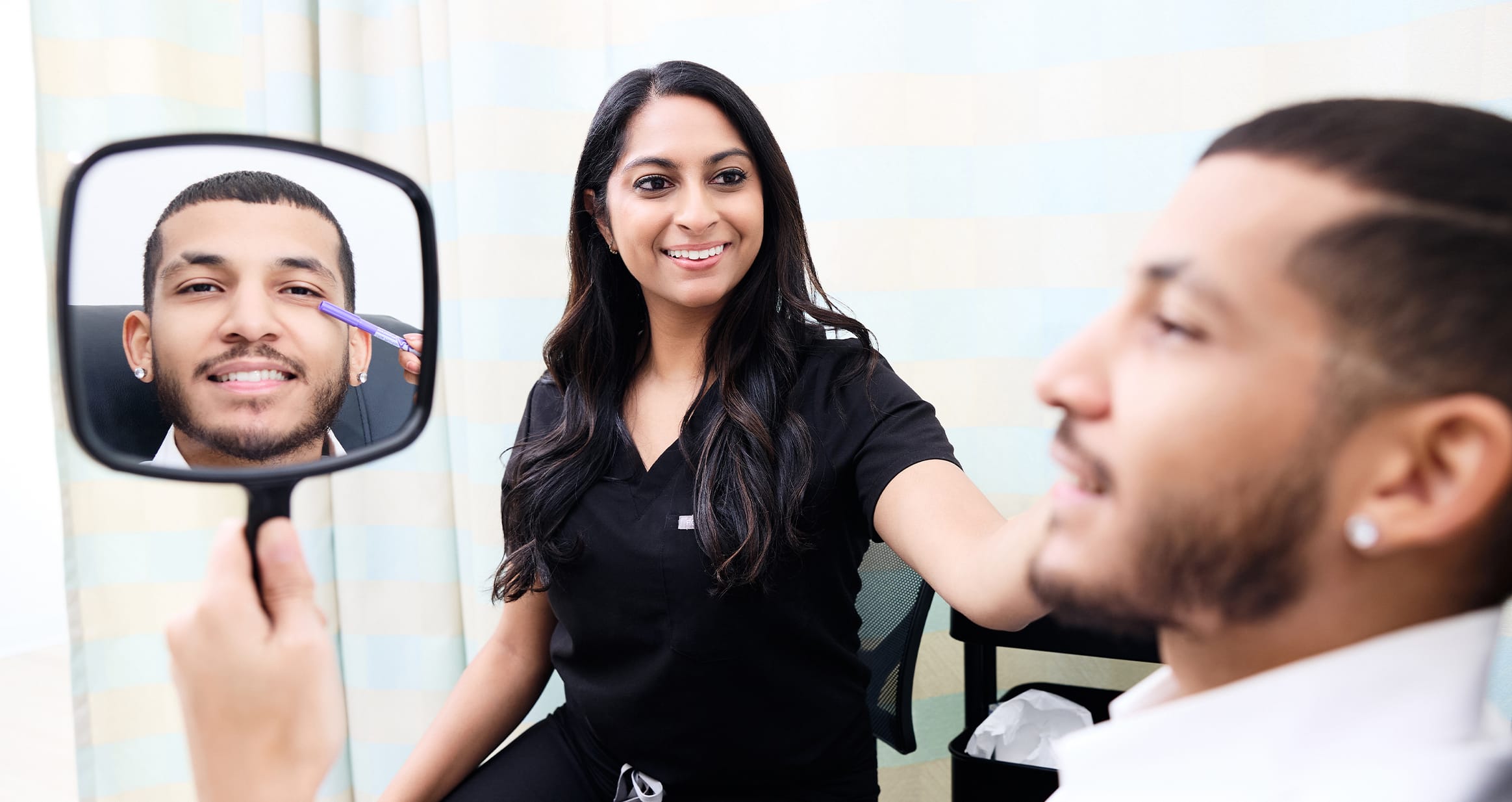 Man looking into mirror smiling