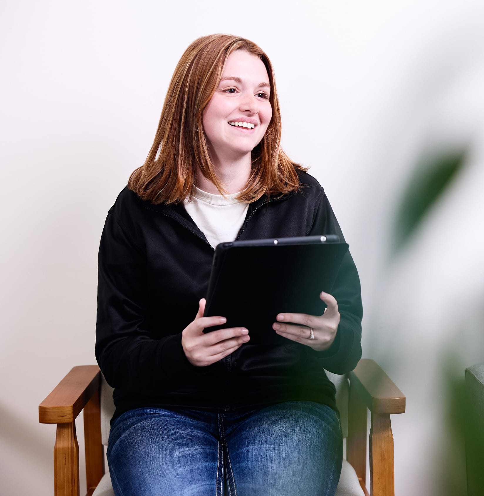 woman smiling holding clipboard