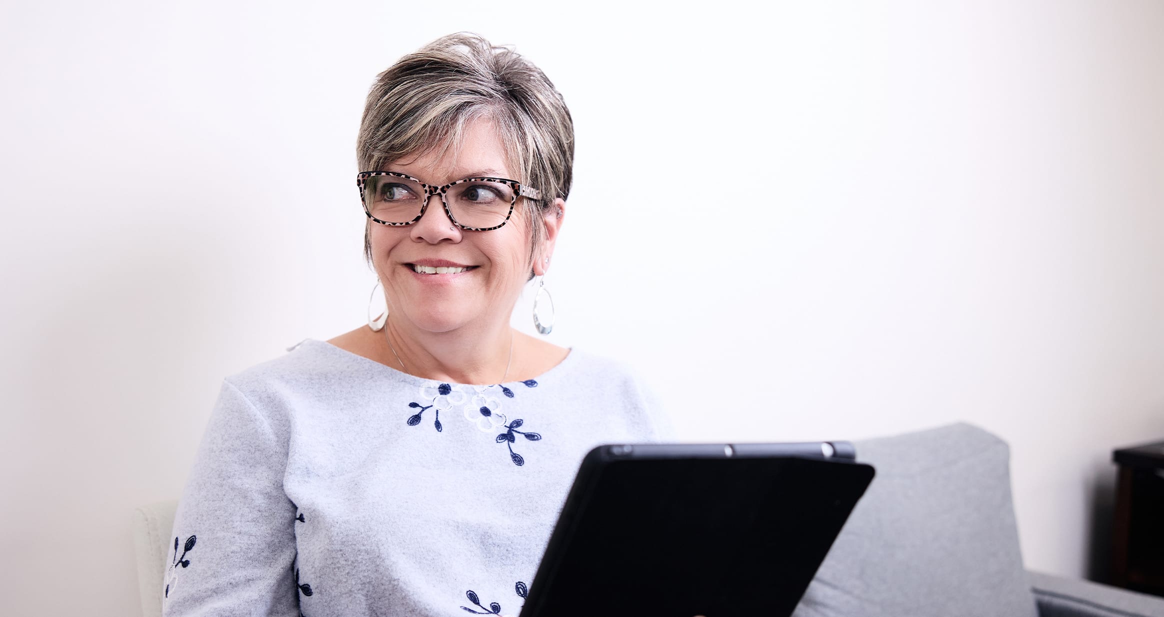 Woman smiling holding clipboard