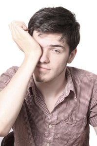 man rubbing his eye